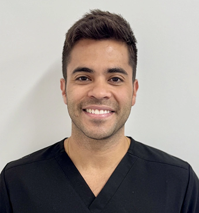 dr eduardo portrait smiling in dark scrubs at dentist in tisdale, sk