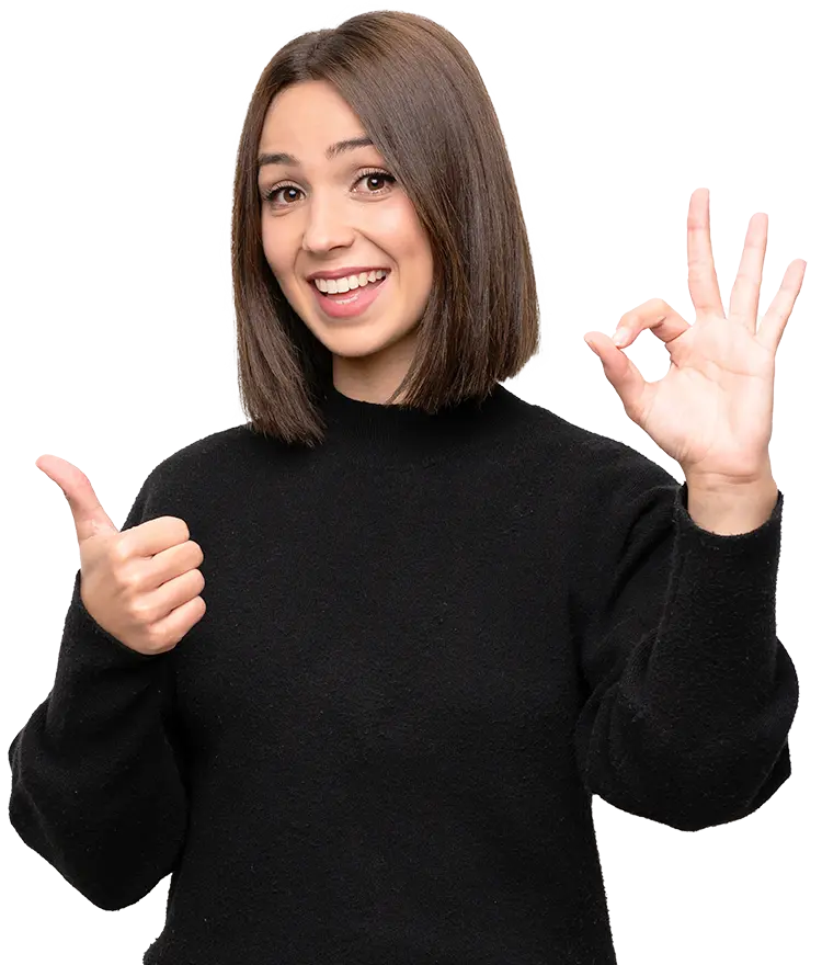 smiling woman making ok hand sign at dentist near you